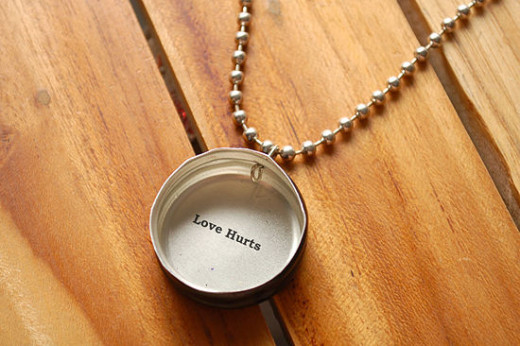 A representation of a necklace with a message on it. 