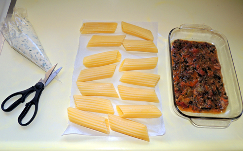 mise en place to assemble the manicotti - snip off end of pastry bag
