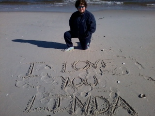 THE OCEAN IS NOW MY HOME AND HERE I WRITE TO MY WIFE IN THE SAND OF THE BEACH.."I LOVE YOU LINDA"