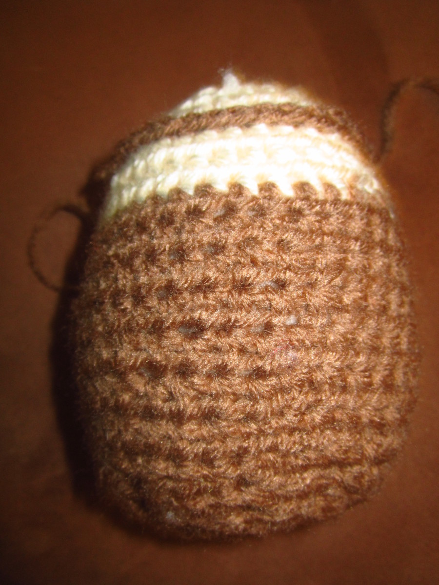 Crochet SC row around off white part.