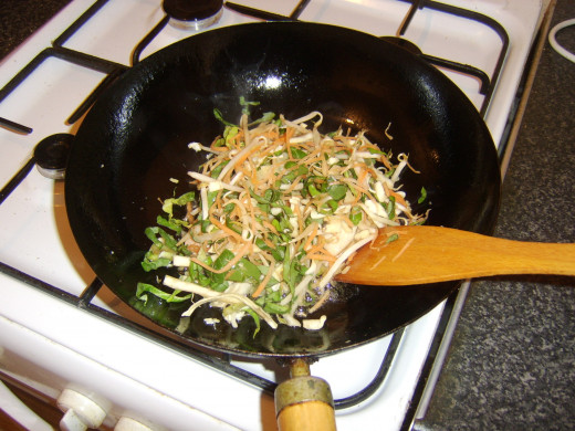Mixed vegetables are added to the wok with the turkey