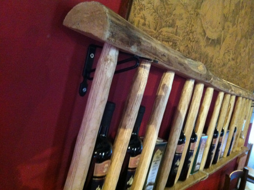 Wine rack from an old wooden step ladder is a feature of a Maremma trattoria
