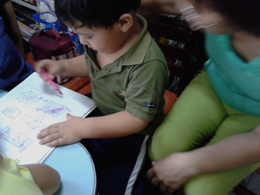 Rami knows how to color with guidance.