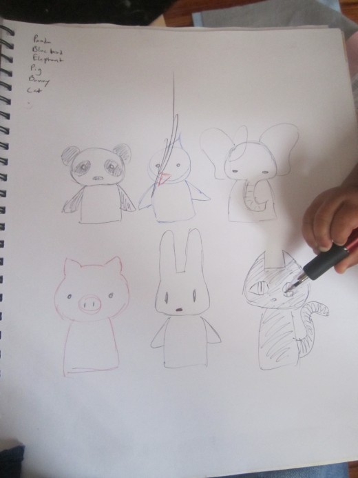 Here I sketched some animals I wanted to make finger puppets for (with Juju's help as you can see); a panda, a pig (Juju's favorite animal currently), an elephant, a bird, a bunny, and a cat.  Keep it as simple as you can!