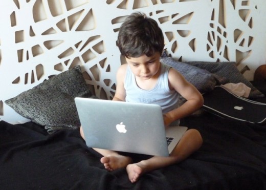 The young photographer studying the images he took with intense concentration.