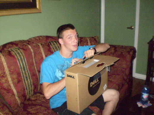 My son opening his high school graduation gift from me.