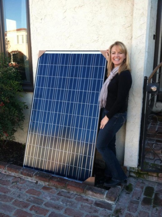 Trying her bit to protect the environment! Installing solar panels.