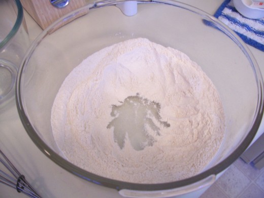 After mixing the dry ingredients together, create a well in the center.