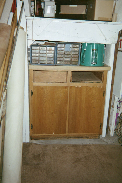 Cabinet from kitchen now under the basement stairwell.