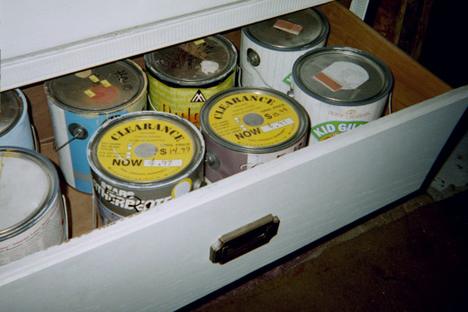 One of the drawers holding 8 gallon cans of paint.