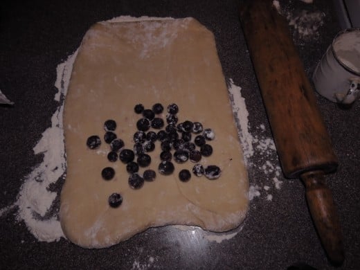 Spreading blueberries on dough
