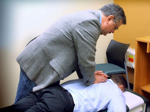 A chiropractor performing a spinal adjustment