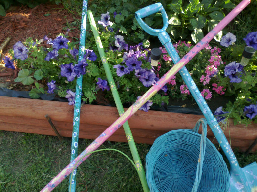 Even when left lying about, these colorful garden tools add cheerfulness to your back yard landscape.