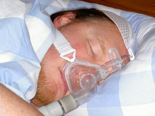 Sleep Apnea Sufferer Wearing CPAP Mask for Treatment