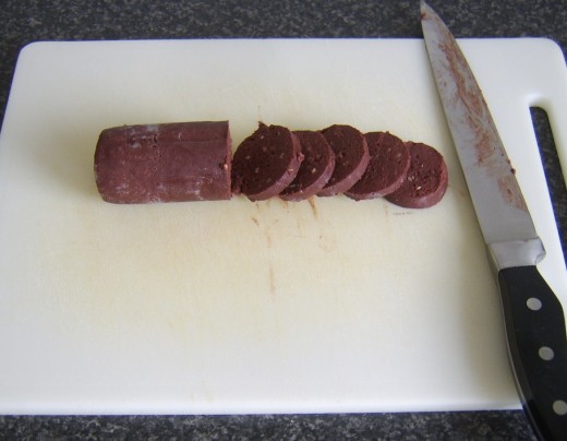Slicing black pudding for frying
