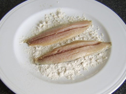 Herring fillets are patted in seasoned flour