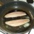 herring fillets are added to the frying pan skin sides down