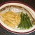 Chips and green beans are plated alongside whiting