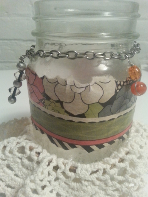 Cut a piece of jewelry chain and affix around the jar neck, complete with findings on the ends.