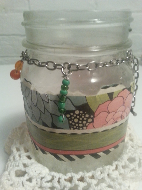 Using jewelry beads and wire, create dangling ornaments of varying lengths to attach to the chain around the jar.