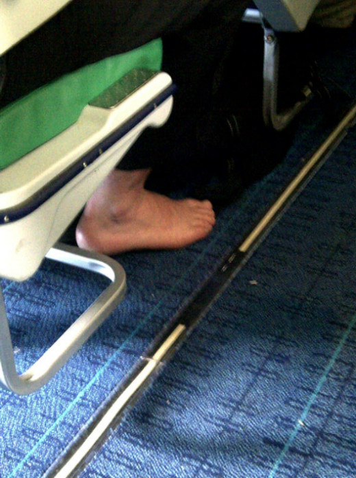 The seemingly happy feet, stinking out everyone around them. Classic airplane sight.