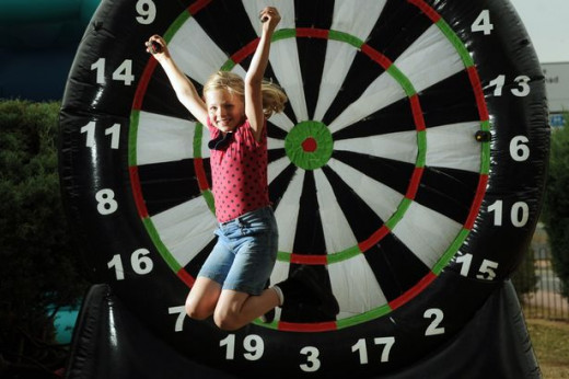 Charlotte Tucker, eight, scores one hundred and eighty on the giant dartboard at Ty Hafan's fundraising event