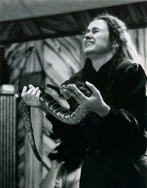 Image depicting a person in a state of ecstasy holding a poisonous snake.  This is common in "snake-handling" churches.
