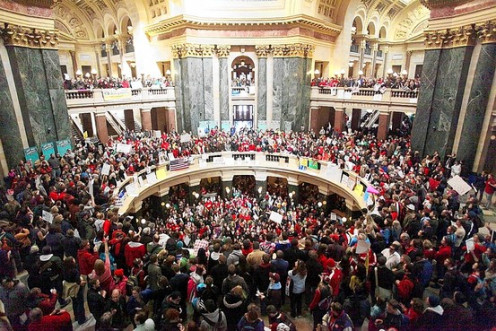 In Madison, Wis., thousands protested a plan to balance the state's budget in part by stripping public workers of bargaining rights.