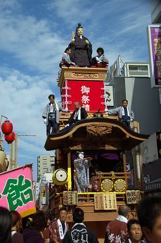Elaborate effigies mounted on floats being paraded in the streets during the Kawagoe Festival