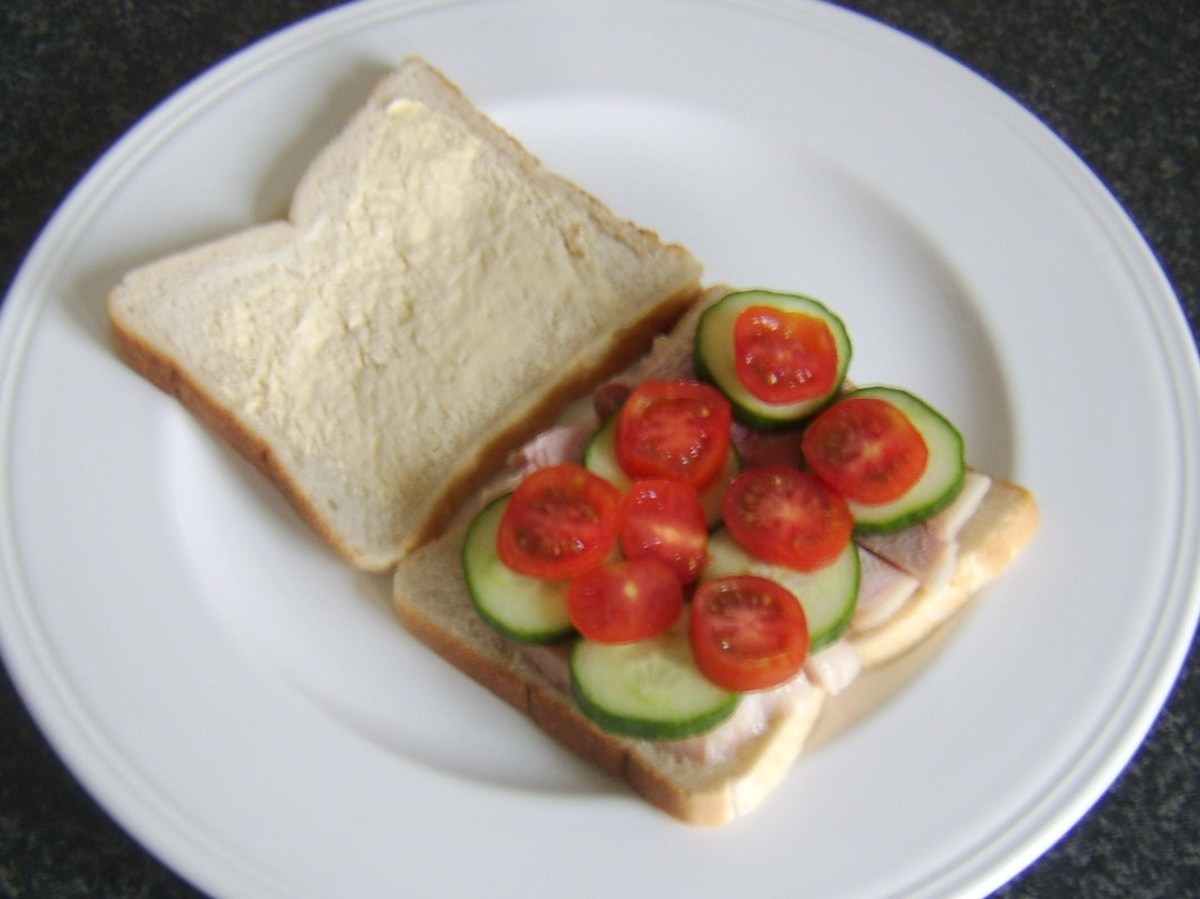 Slices of cucumber and tomato are laid on top of ham