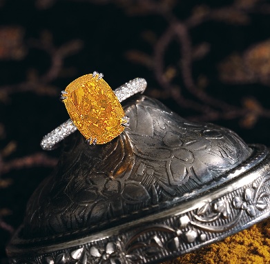This 4.19 fancy vivid orange diamond ring sold for a world record price of $2.96 million. (approximately $700,000 per carat) The cushion cut orange diamond is set in an 18k white gold diamond ring.