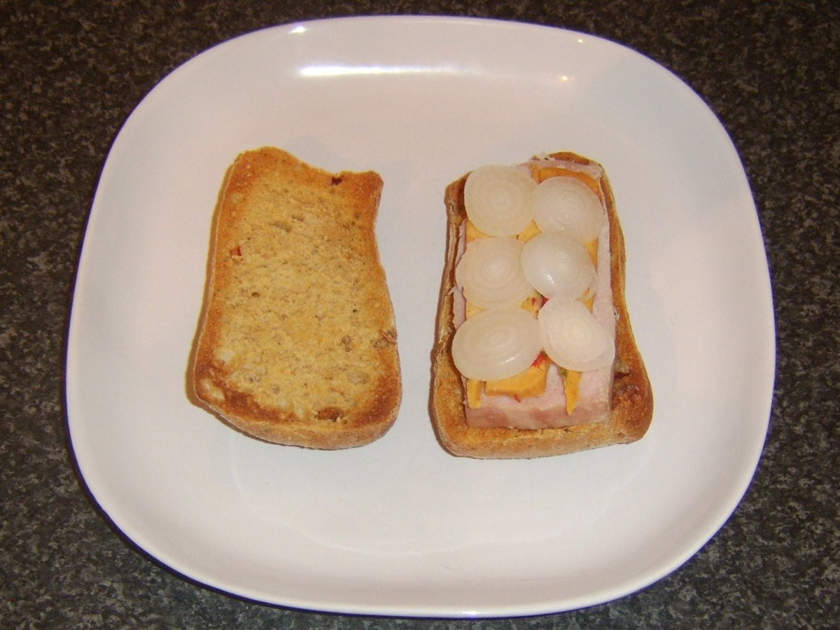 Boiled ham, spicy cheese and pickled onion slices on a toasted sun dried tomato ciabatta bread roll