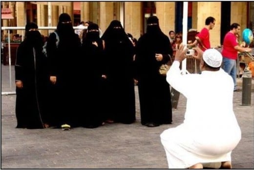 Man  takes a picture of his five wives.