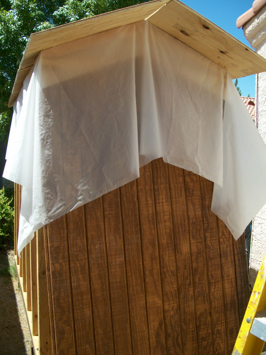 The wall siding is installed under the plastic.
