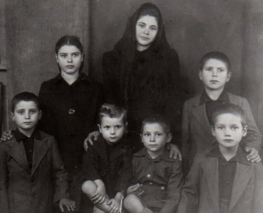 My mother Mary (the oldest in the middle) and her siblings grieving as orphans. 