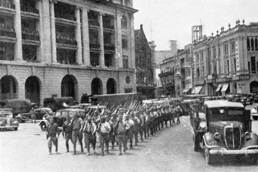 Japanese troops marching through Fullerton Square in downtown Singapore to celebrate their victory