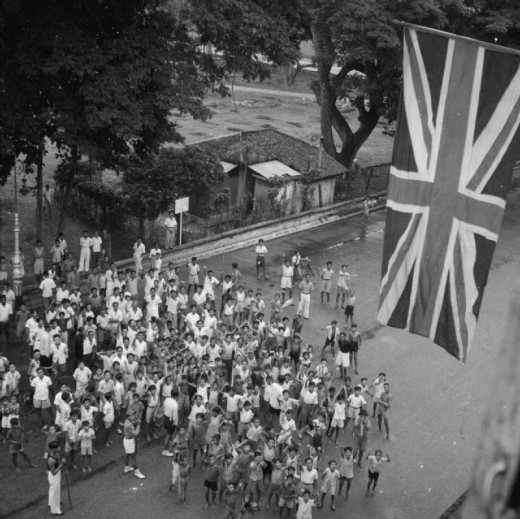 A crowd celebrating the return of the British to Singapore after World War II