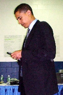 Obama on his Blackberry.