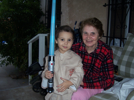Ari dressed up as a Jedi Knight with Grandma.