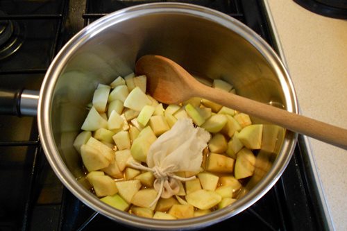 First add your chopped apple, the spice bag (if used) and the apple juice to a large pan.