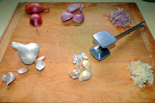 left to right, top to bottom, shallots and garlic prep. (Smacking the garlic clove with a meat mallet facilitates peeling...) Set aside