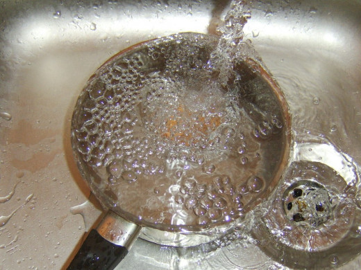 Egg is cooled under running cold water