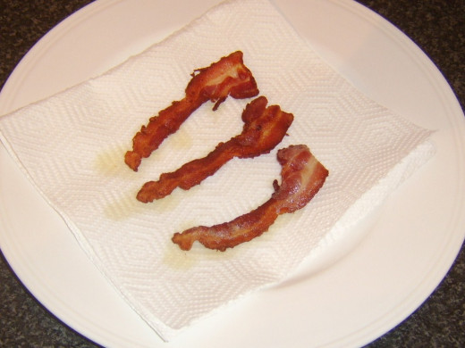 Bacon is drained on kitchen paper