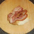 Bacon slices are laid on bread roll base
