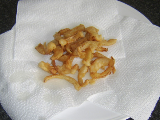 Draining onion fritters on kitchen paper
