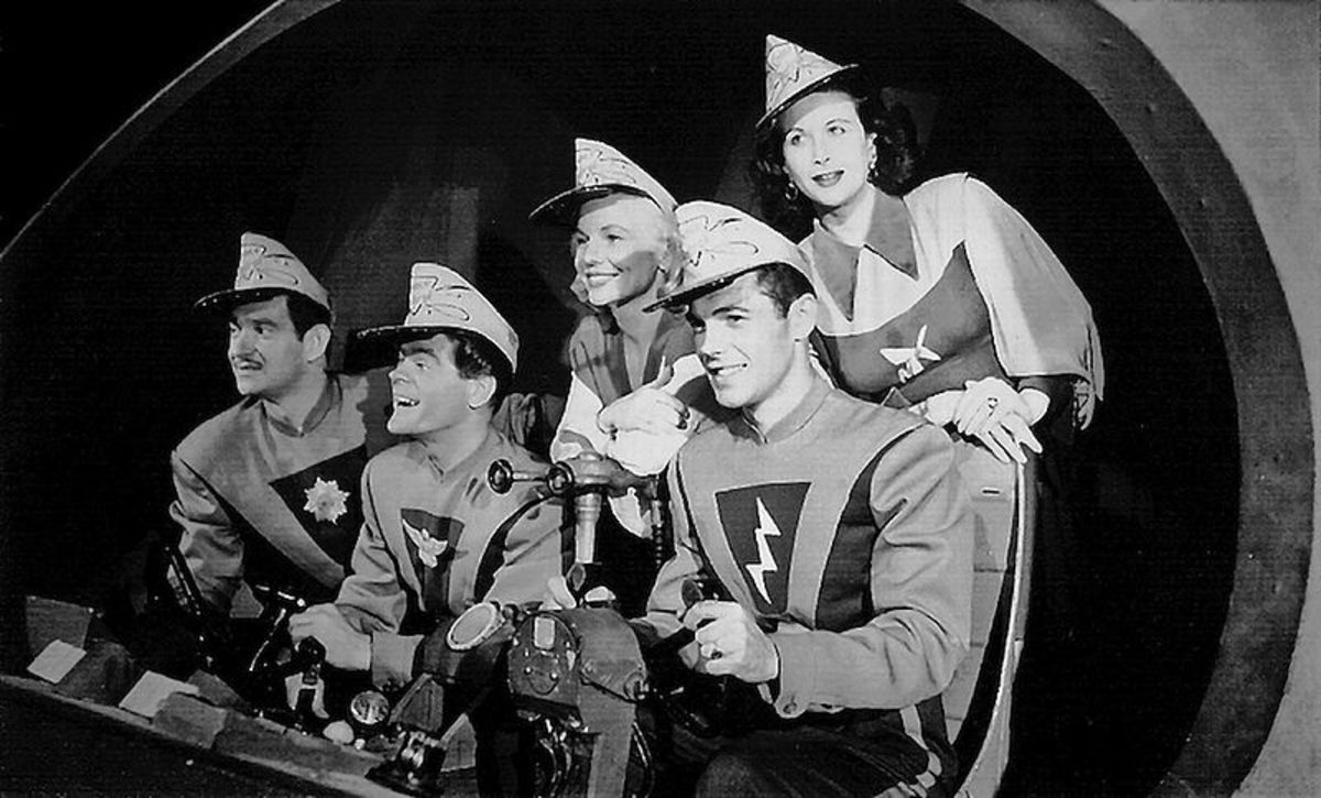 From front right to left: Ed Kemmer - Commander Buzz Corry; Lyn Osborn - Cadet Happy; Ken Meyer - Major Robertson. Back: Nina Bara - Tonga; and Virginia Hewitt - Carol Carlisle. 