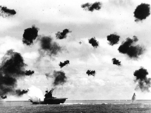 USS Yorktown (CV-5) is hit on the port side, amidships, by a Japanese Type 91 aerial torpedo during the mid-afternoon attack by planes from the carrier Hiryu, in the Battle of Midway, on 4 June, 1942.