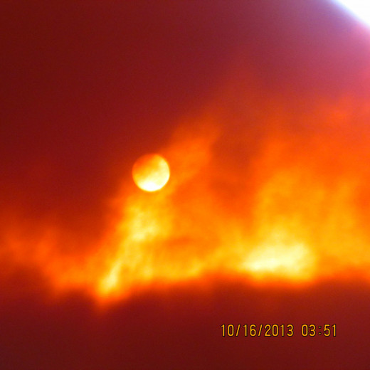 This photo shows Nibiru Planet X clearly outlined as our Sun is to the right behind some clouds.