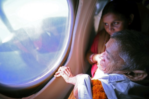 Master Nau looking out an airplane window.