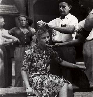 A horizontal collaborator has her head shaved by a group of resisters.